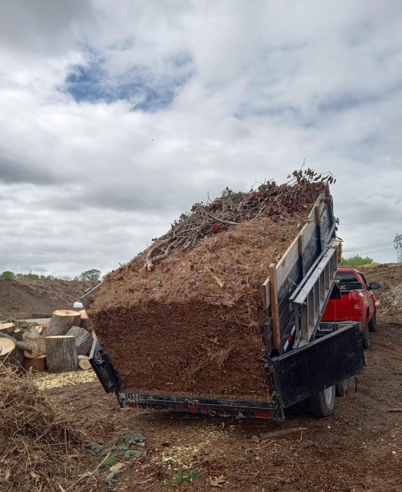 A large pile of dirt is on the back of a dump truck