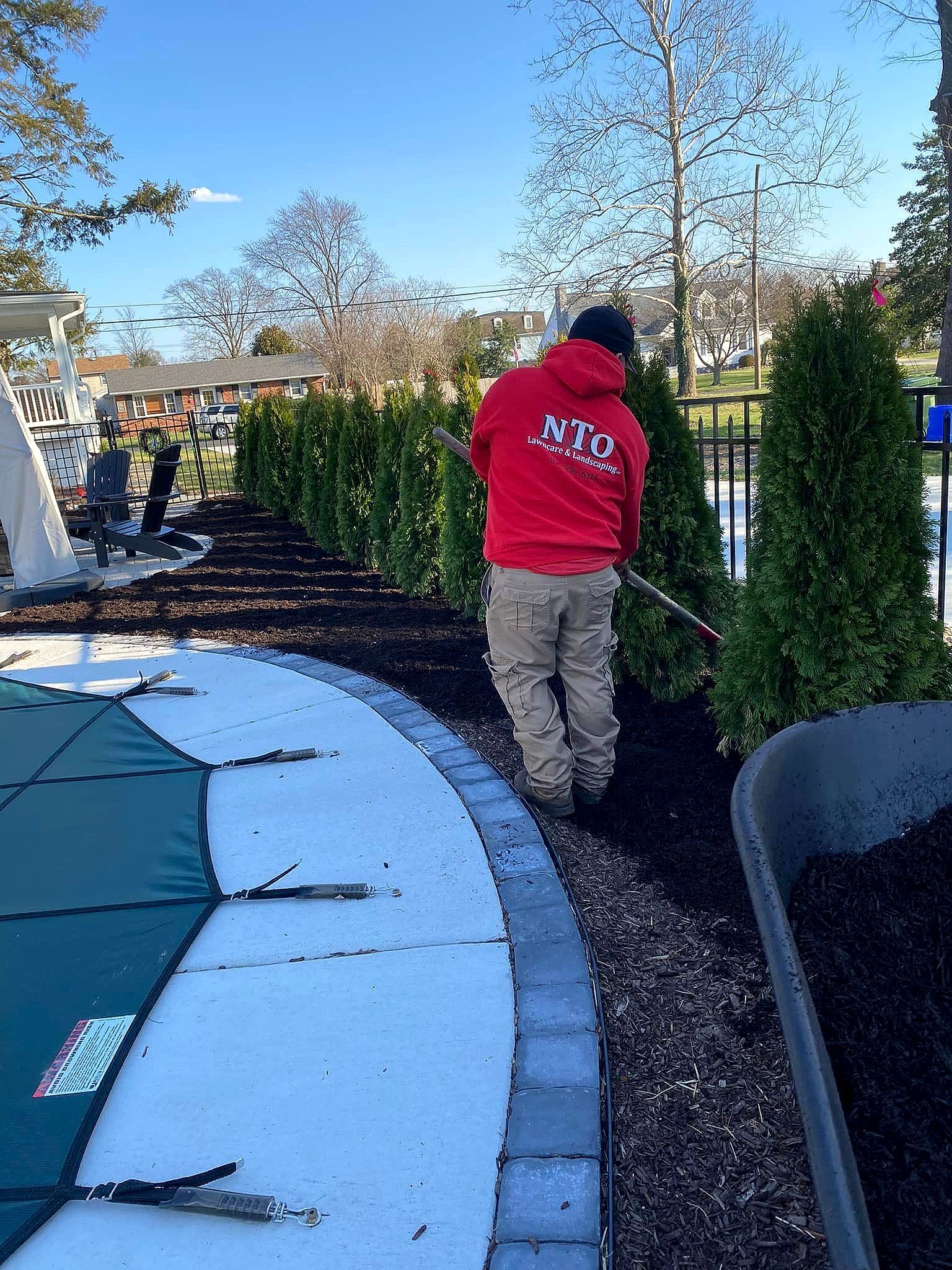 man in red sweatshirt with nto on the back