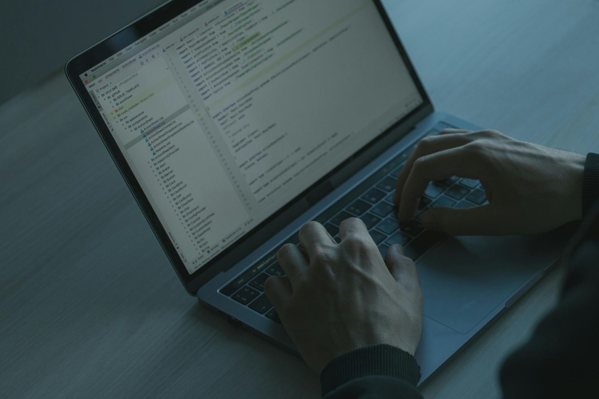 A person is typing on a laptop computer.
