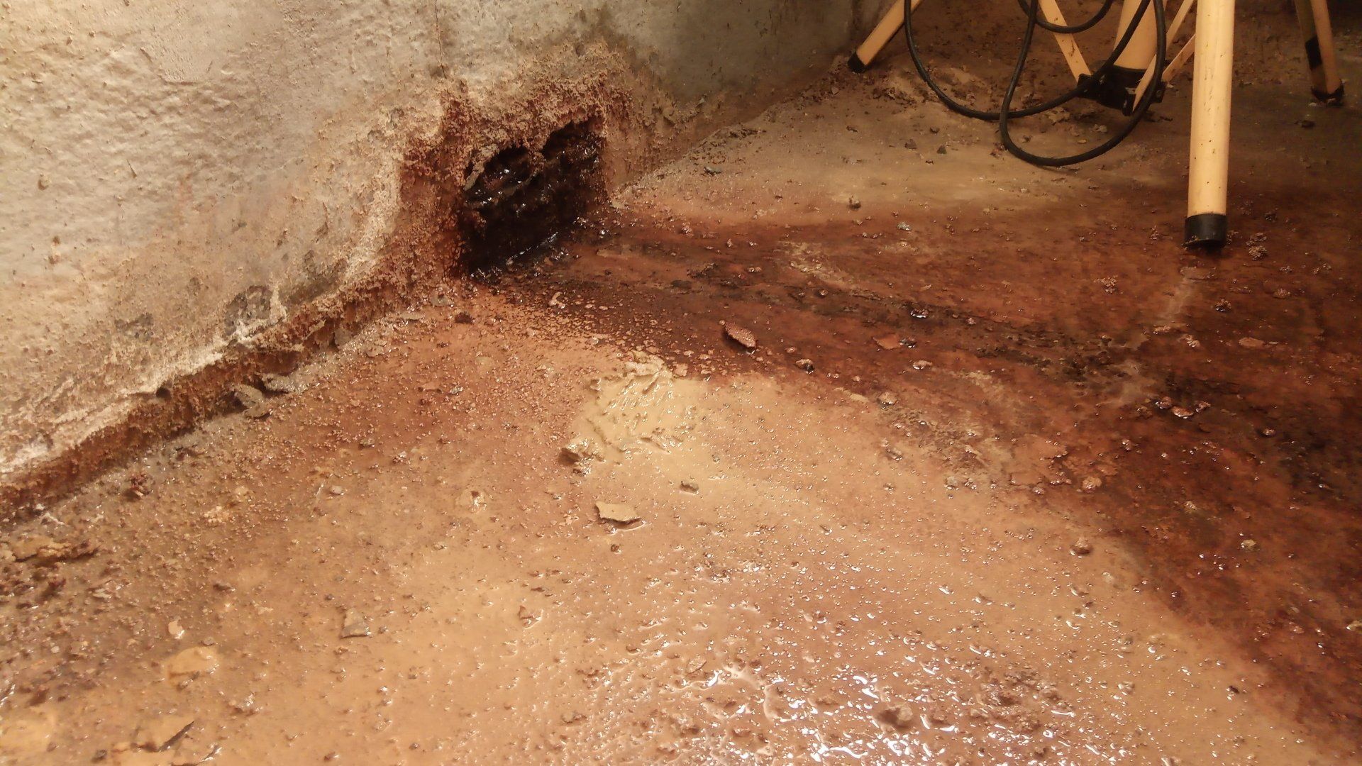 1. Water constantly flowing  from outlet in lower basement