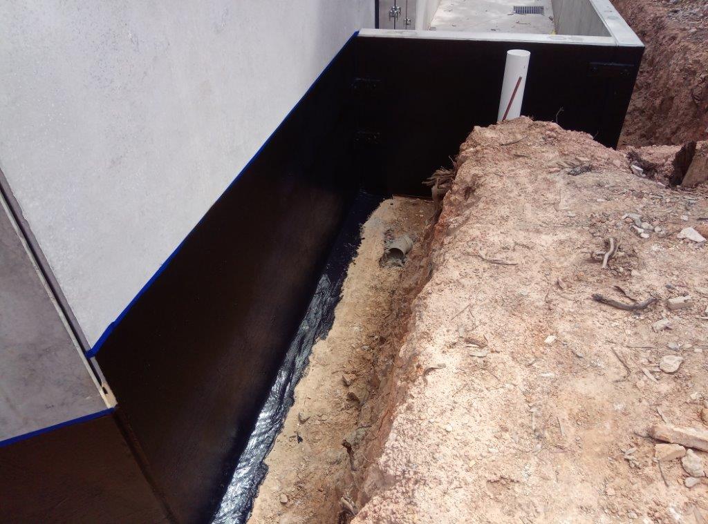 6. Apply 1st coat waterproofer from tape line down onto footings and lay off horizontally