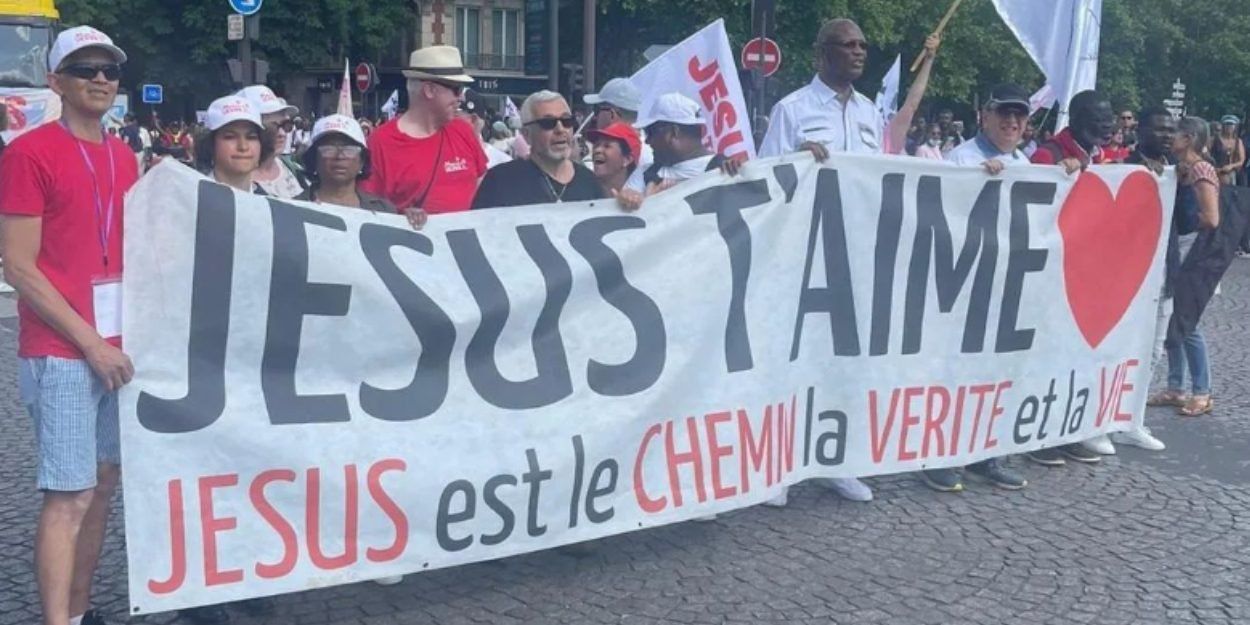 People holding a banner that reads