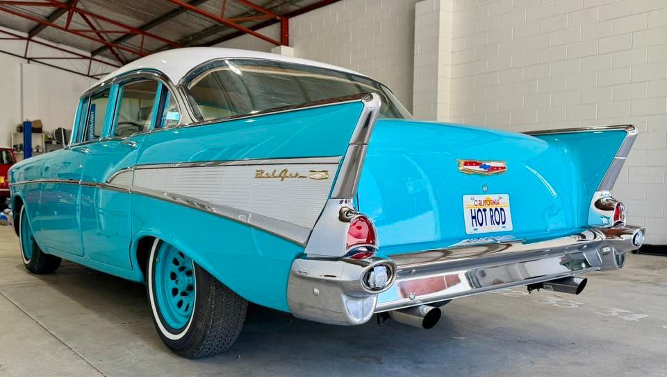 Classic teal and white Chevrolet Bel Air with chrome accents and 