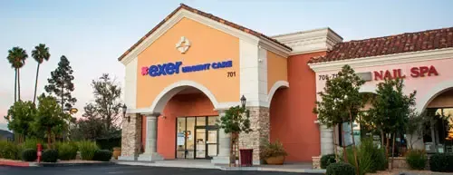 Exterior view of a shopping center with a bank and a nail spa.