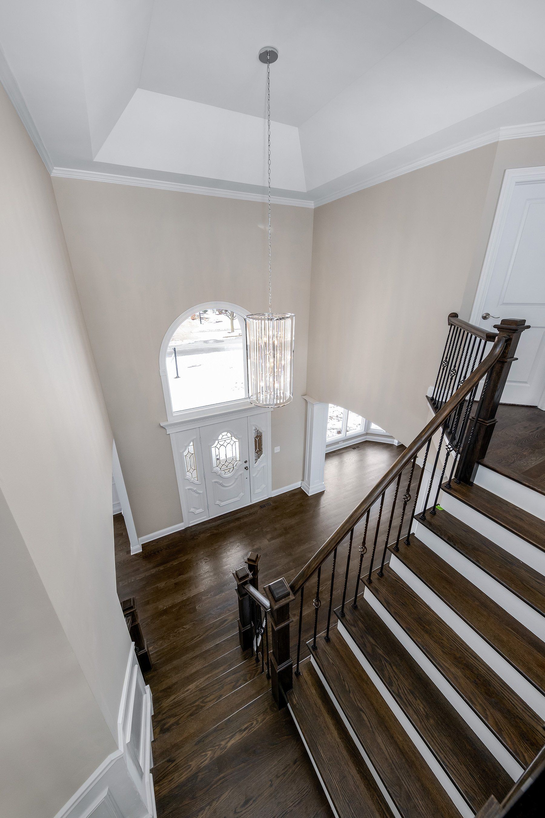 A view of a staircase from the second floor of a house.
