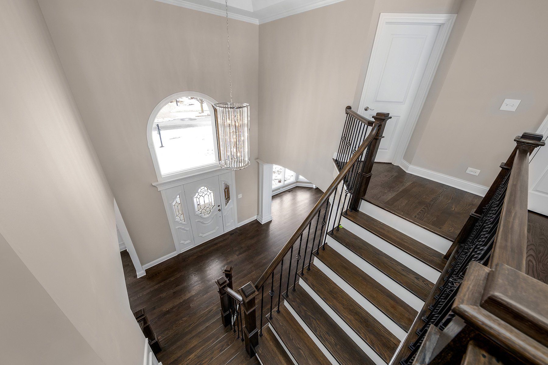 A view of a staircase from the second floor of a house.