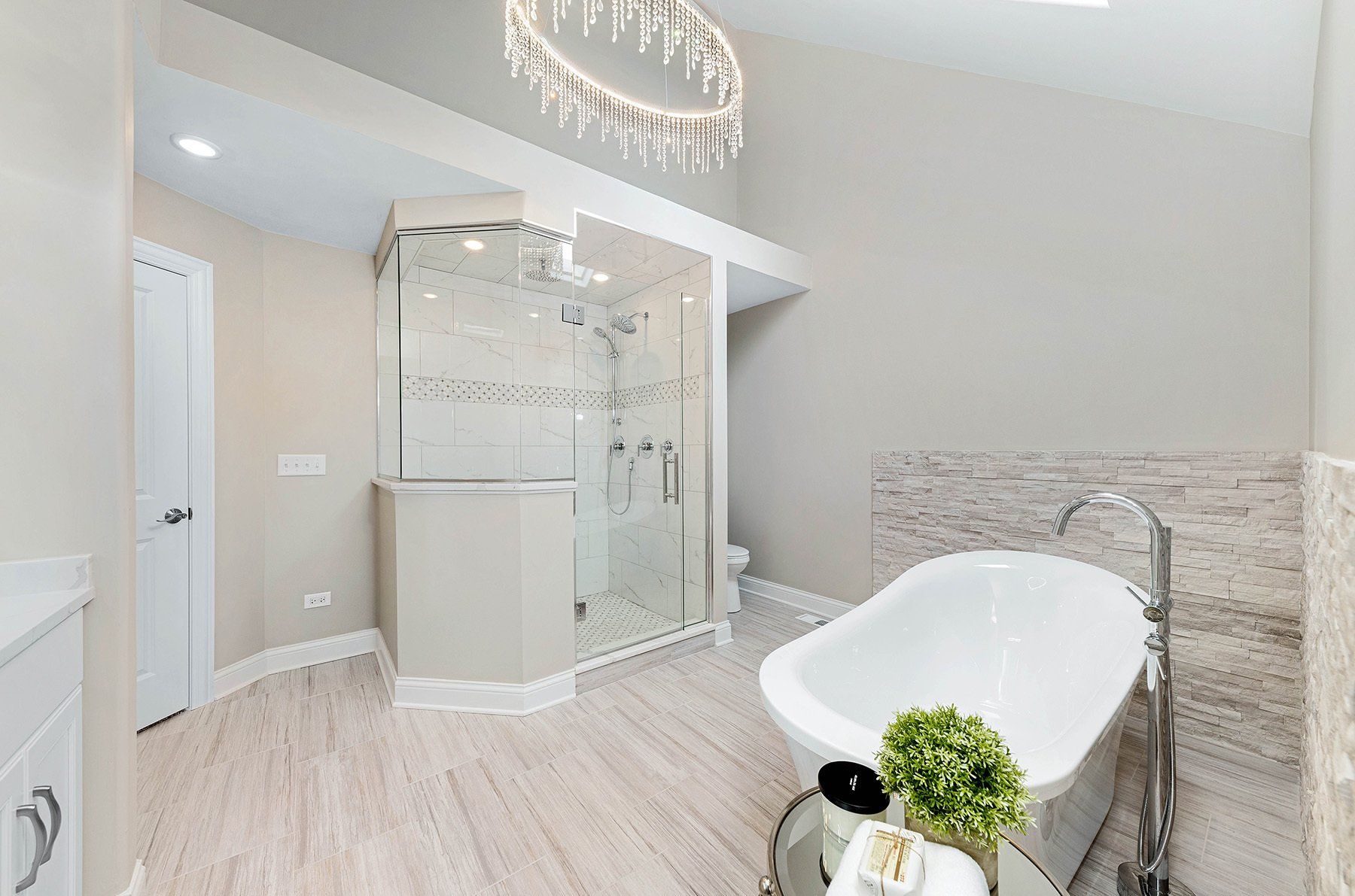 A bathroom with a bathtub and a walk in shower.