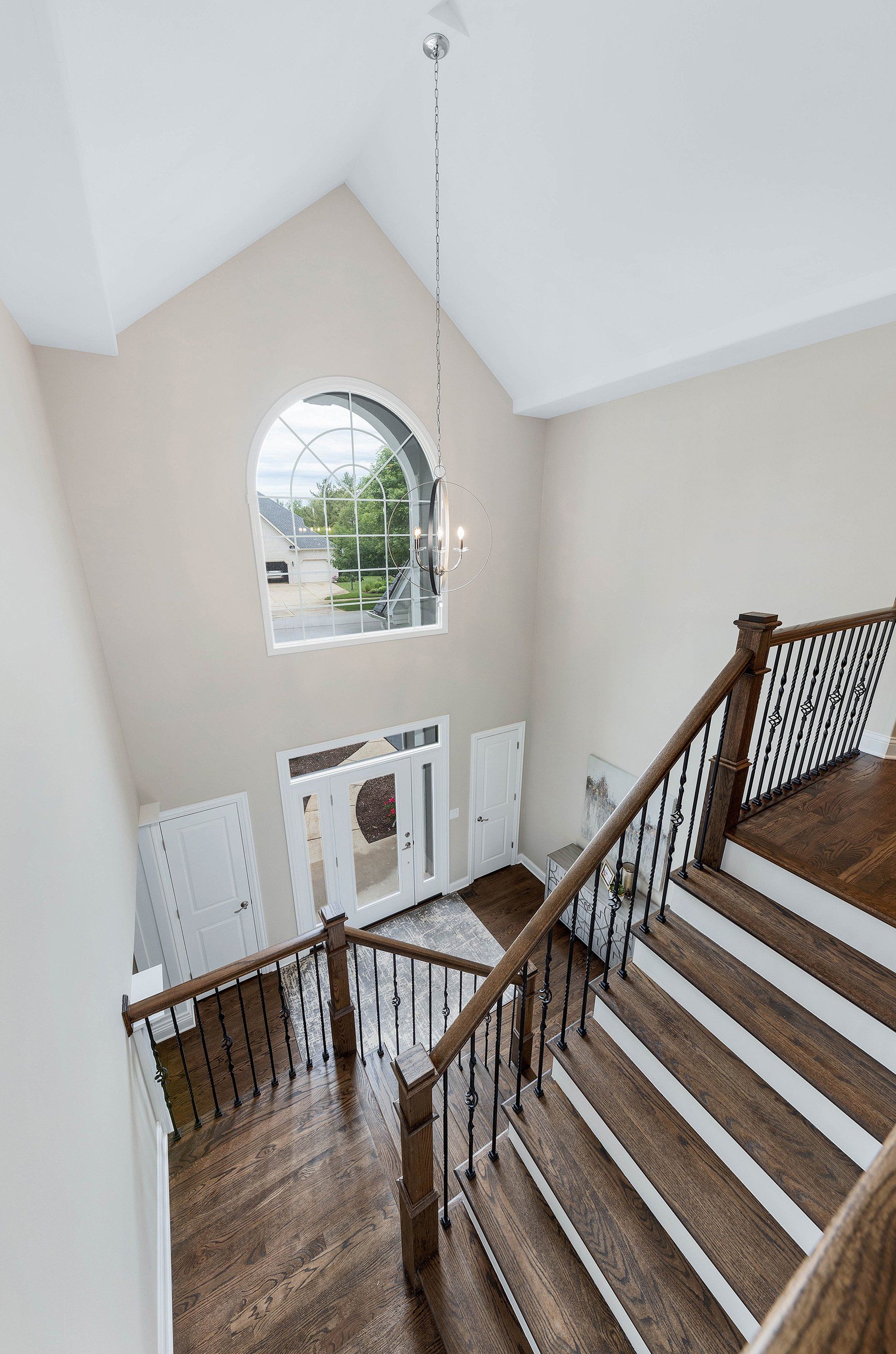 A view of a staircase from the second floor of a house.