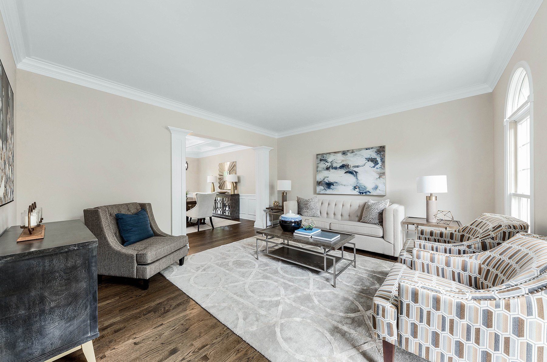 A living room with a couch , chairs , and a coffee table.