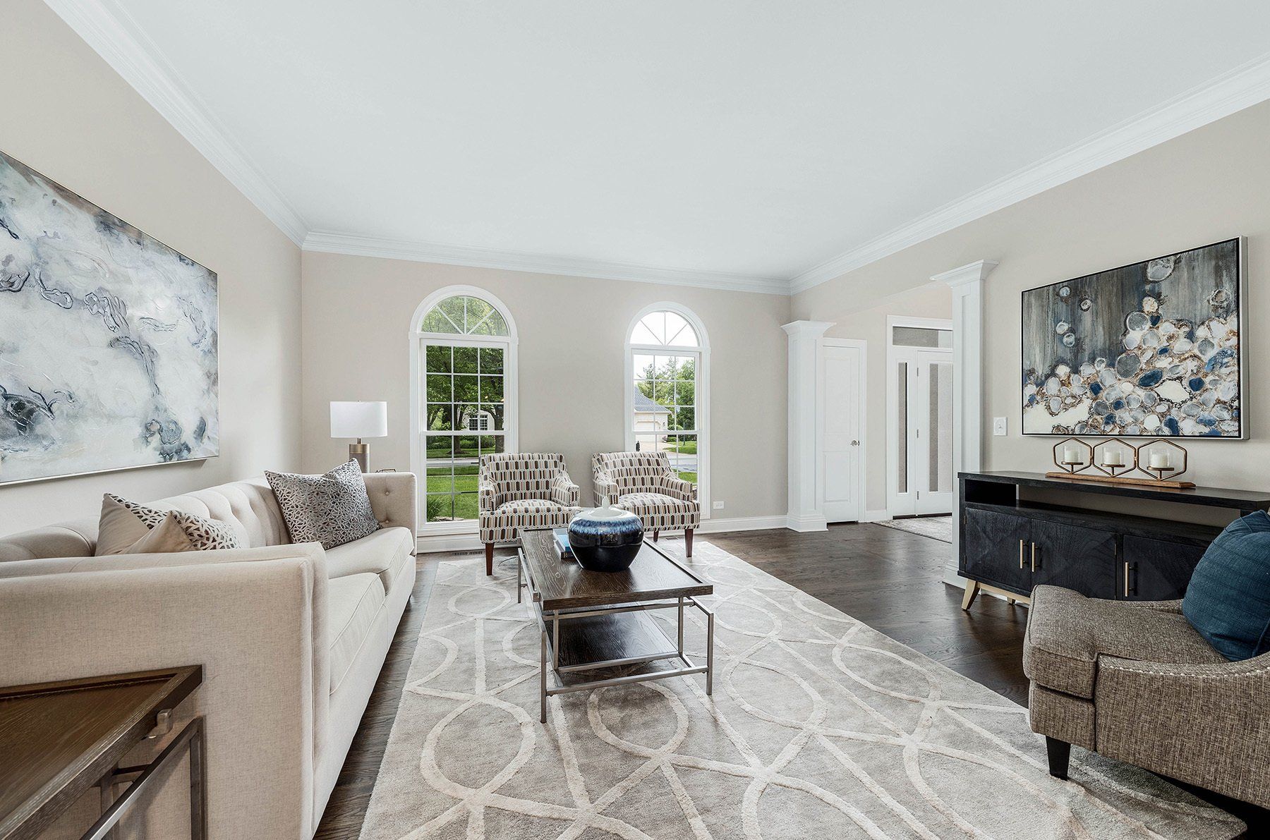 A living room with a couch , chairs and a coffee table