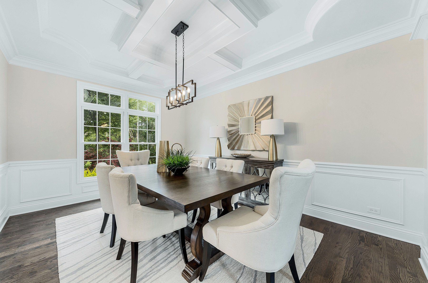 A dining room with a table and chairs and a chandelier.