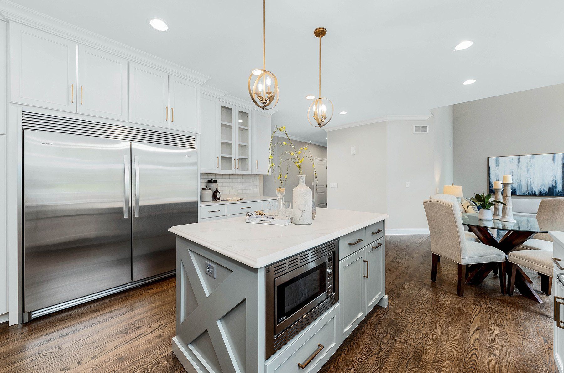 A kitchen with a large island and stainless steel appliances.