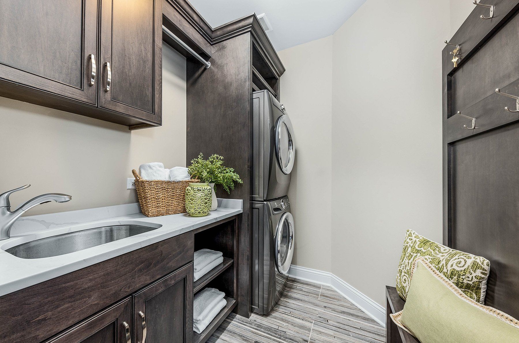 A laundry room with a sink , washer and dryer , and refrigerator.