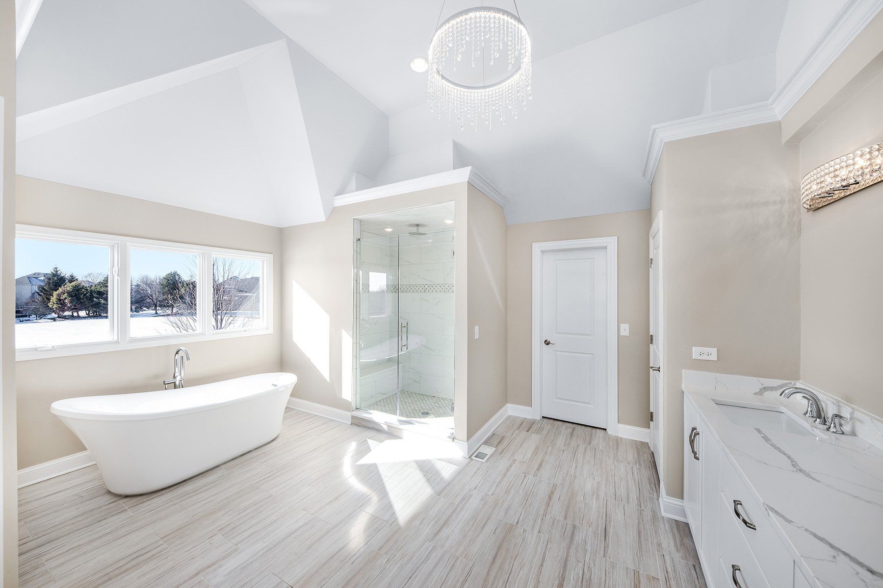 A bathroom with a bathtub , sink , and shower.