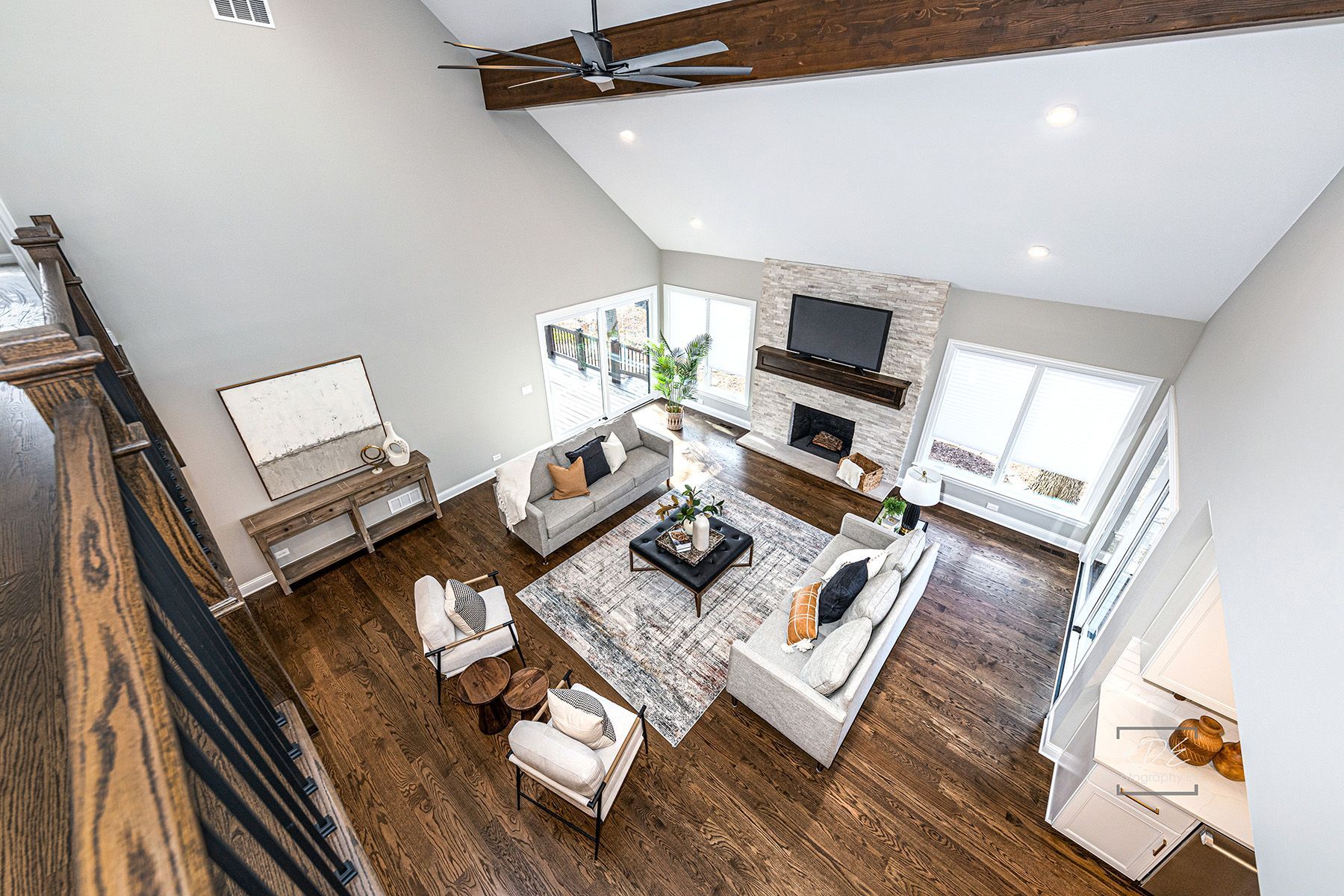 An aerial view of a living room filled with furniture and a fireplace.