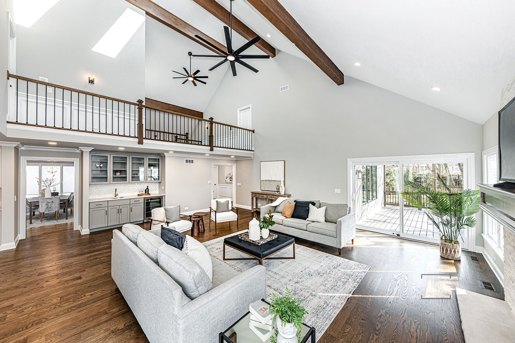 A living room filled with furniture and a ceiling fan.