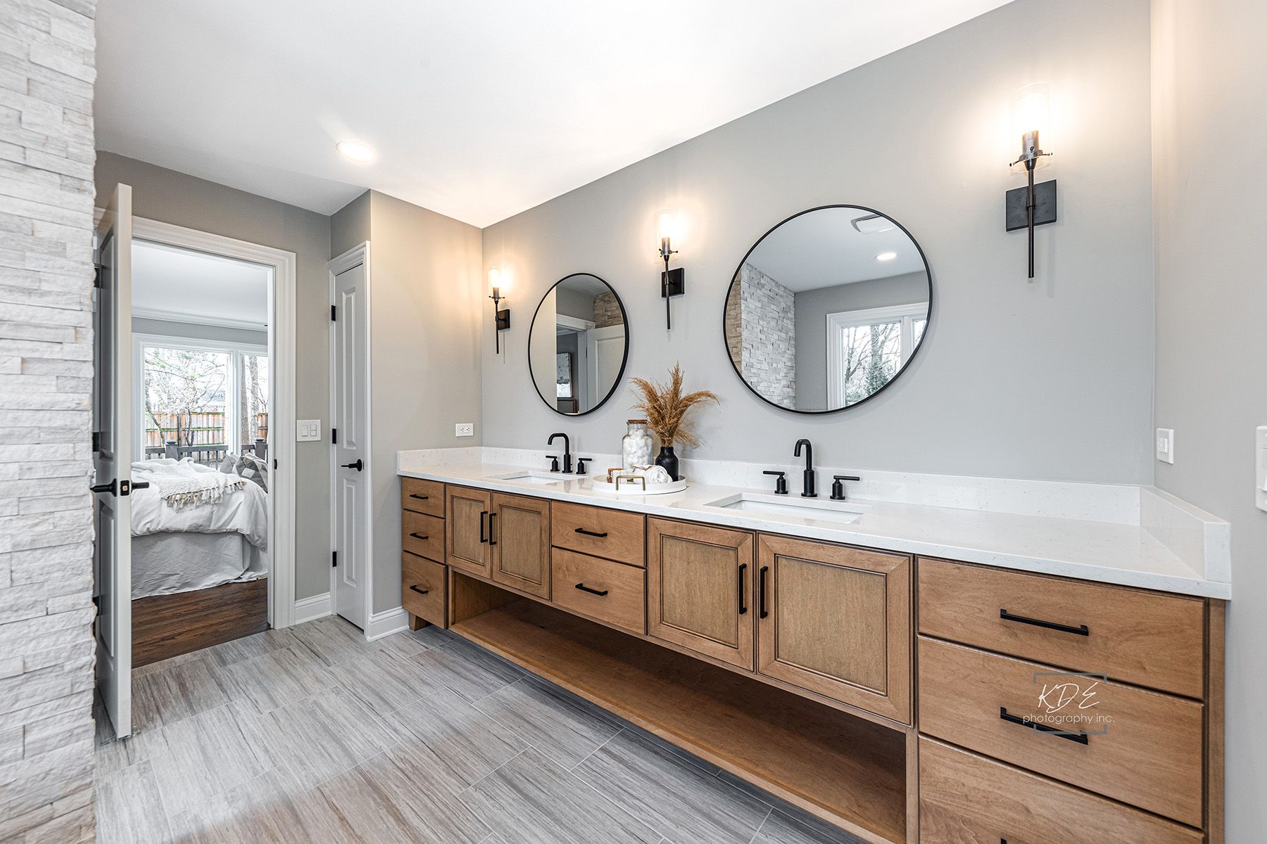A bathroom with two sinks and two mirrors.