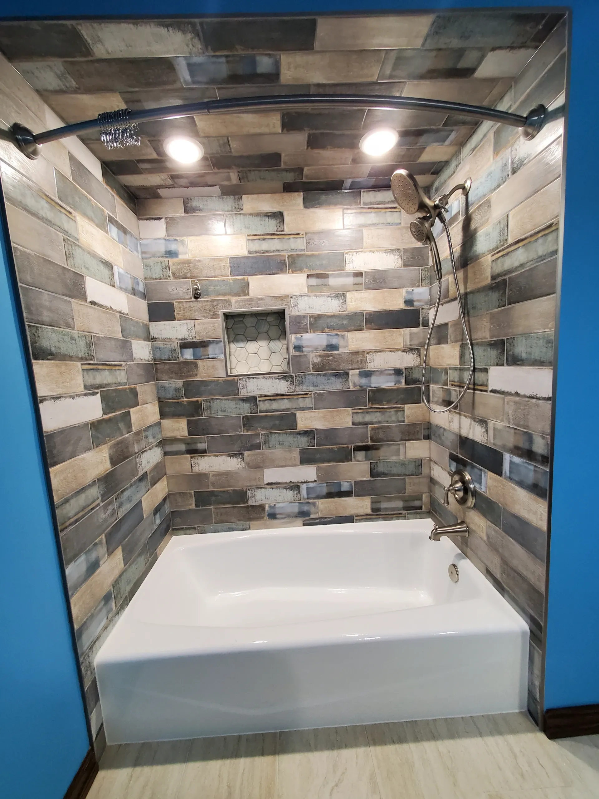 A bathroom with a bathtub and a shower.