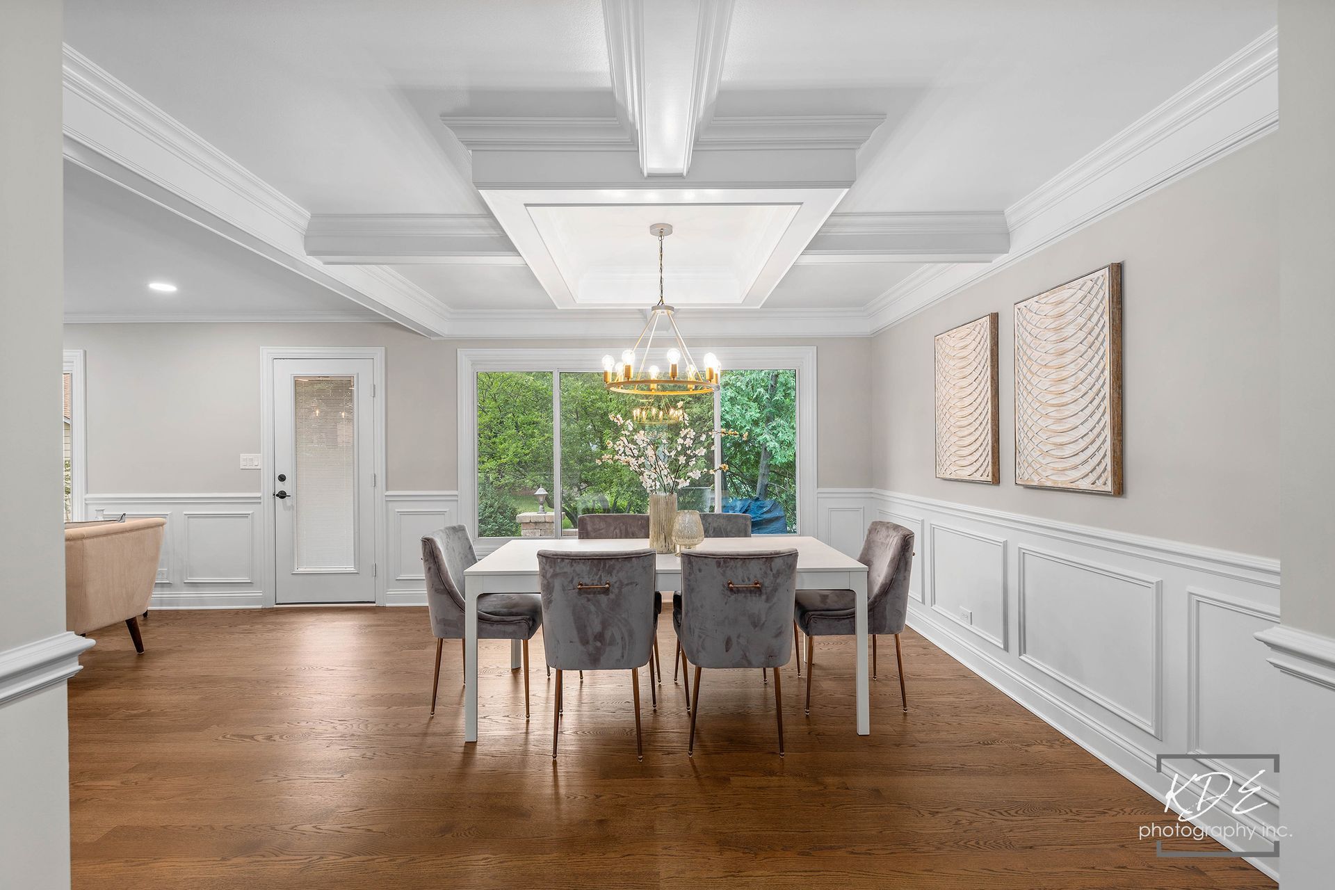 A dining room with a table and chairs and a chandelier.