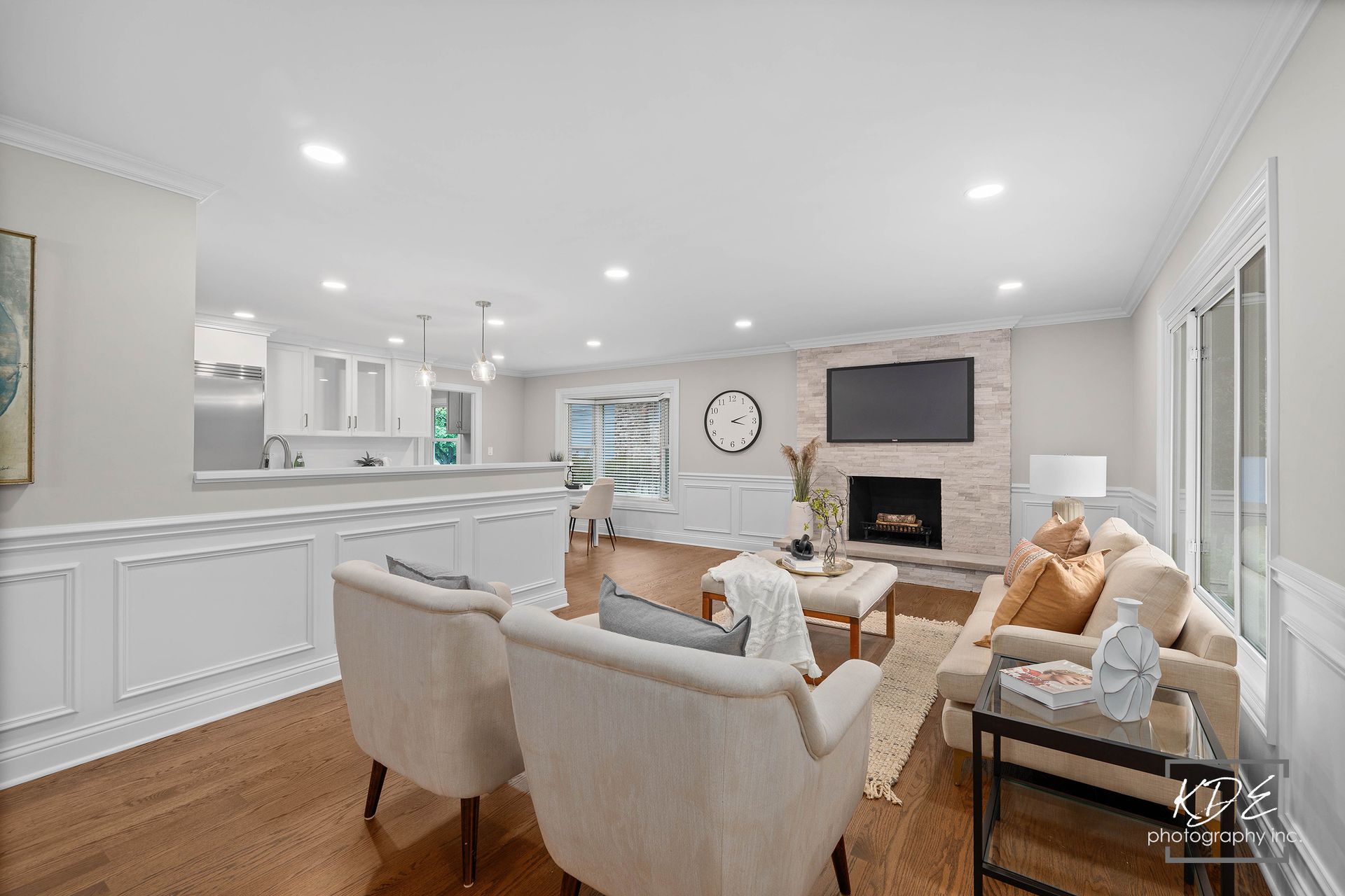 A living room with a couch , chairs and a fireplace.
