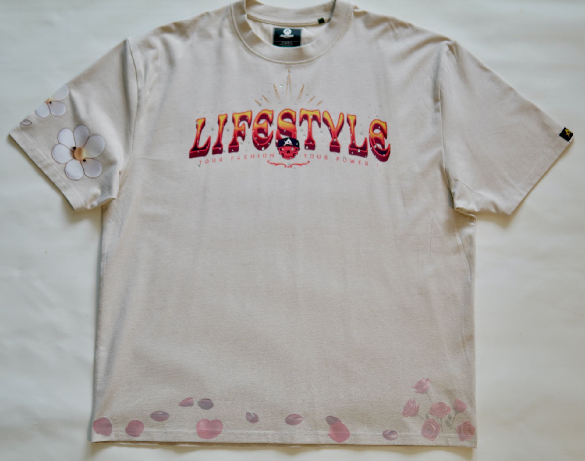 Front view of an Ecru Custom-made with gradient flame-style lettering, 3D rhinestone accents (bling), and soft floral prints on premium cotton. Featuring the Austeez Noble Family woven tag – made for those who live loud but love quiet.
Pre-release drop. Made in limited quantities.