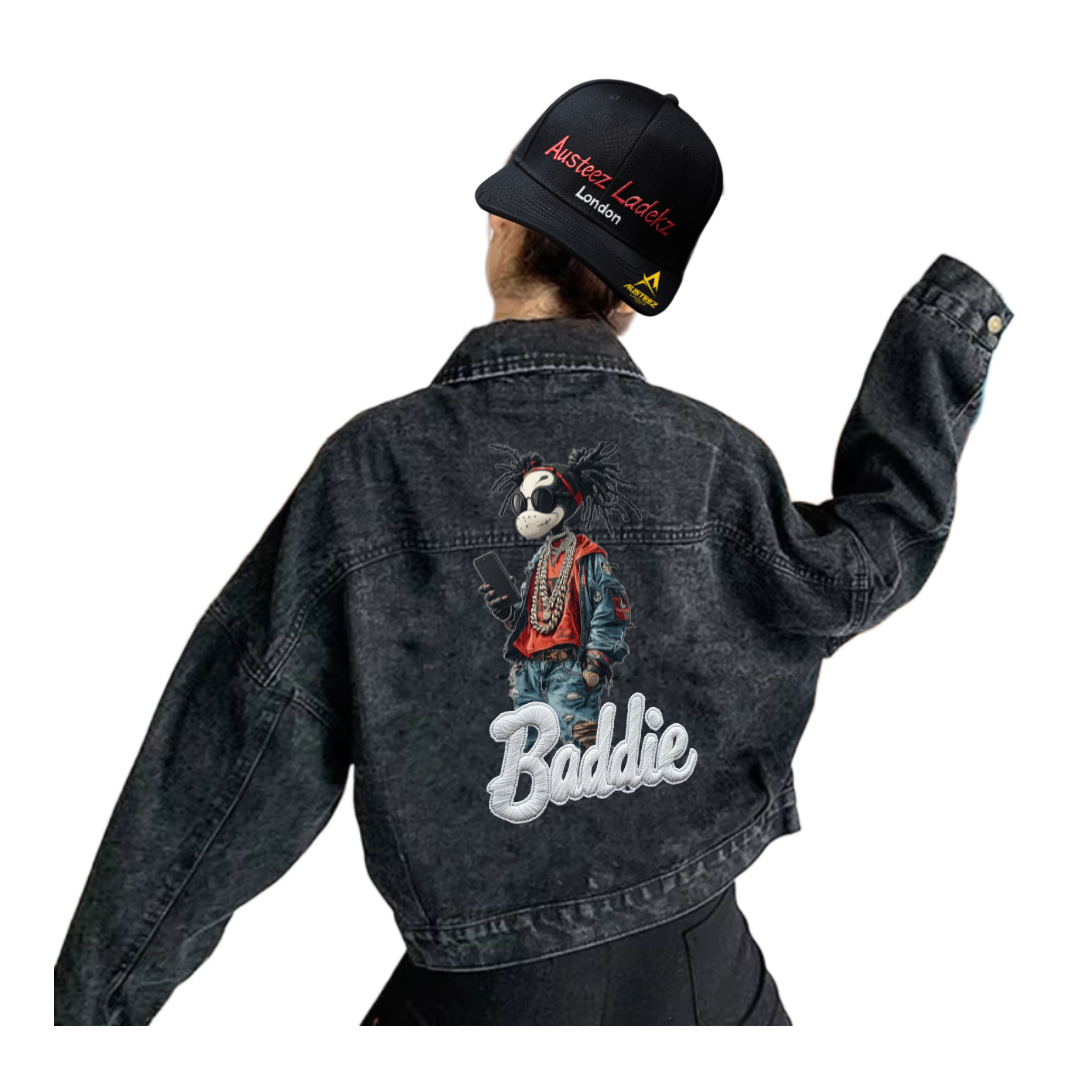 Person wearing a black denim jacket with a cartoon dog graphic and 