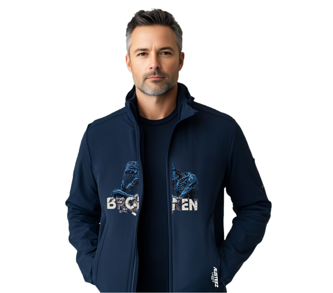 Man wearing a navy blue jacket with a graphic, standing against a white background.