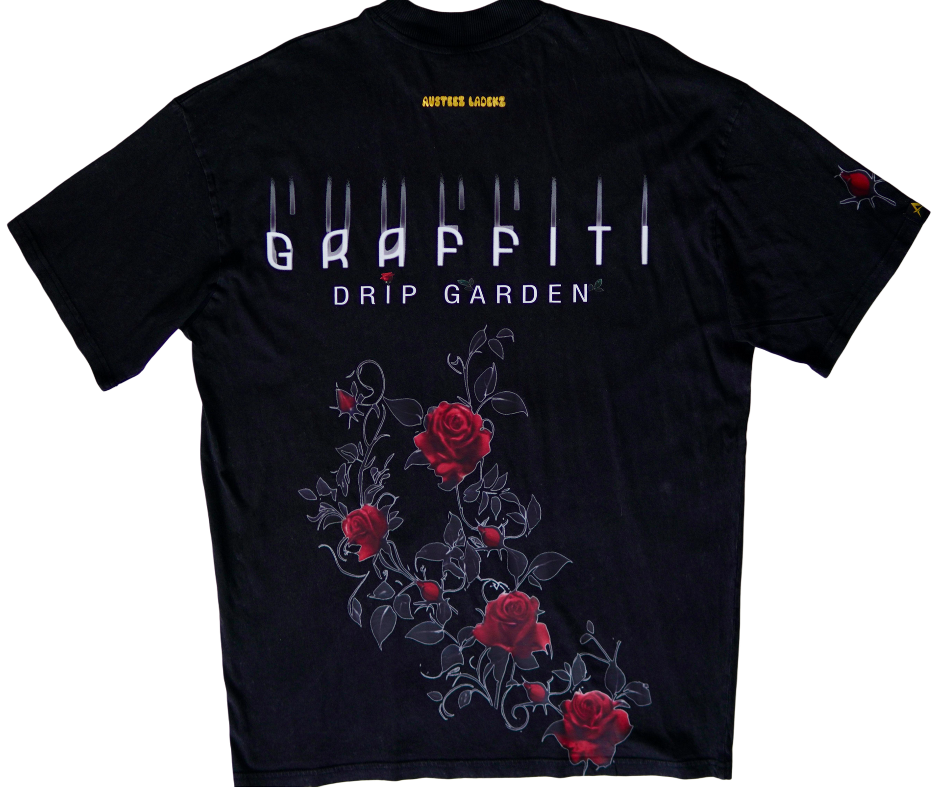 Off-white t-shirt with floral design, red roses to the side and petals scattered below.
