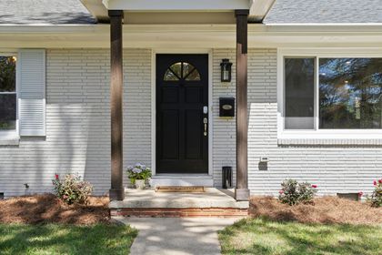 a freshly painted black door of a home