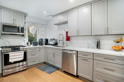 a kitchen with grey painted cabinets