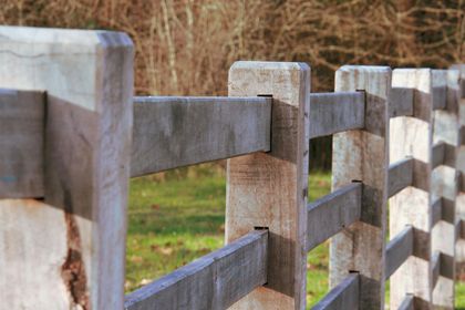a wooden fence that needs painted