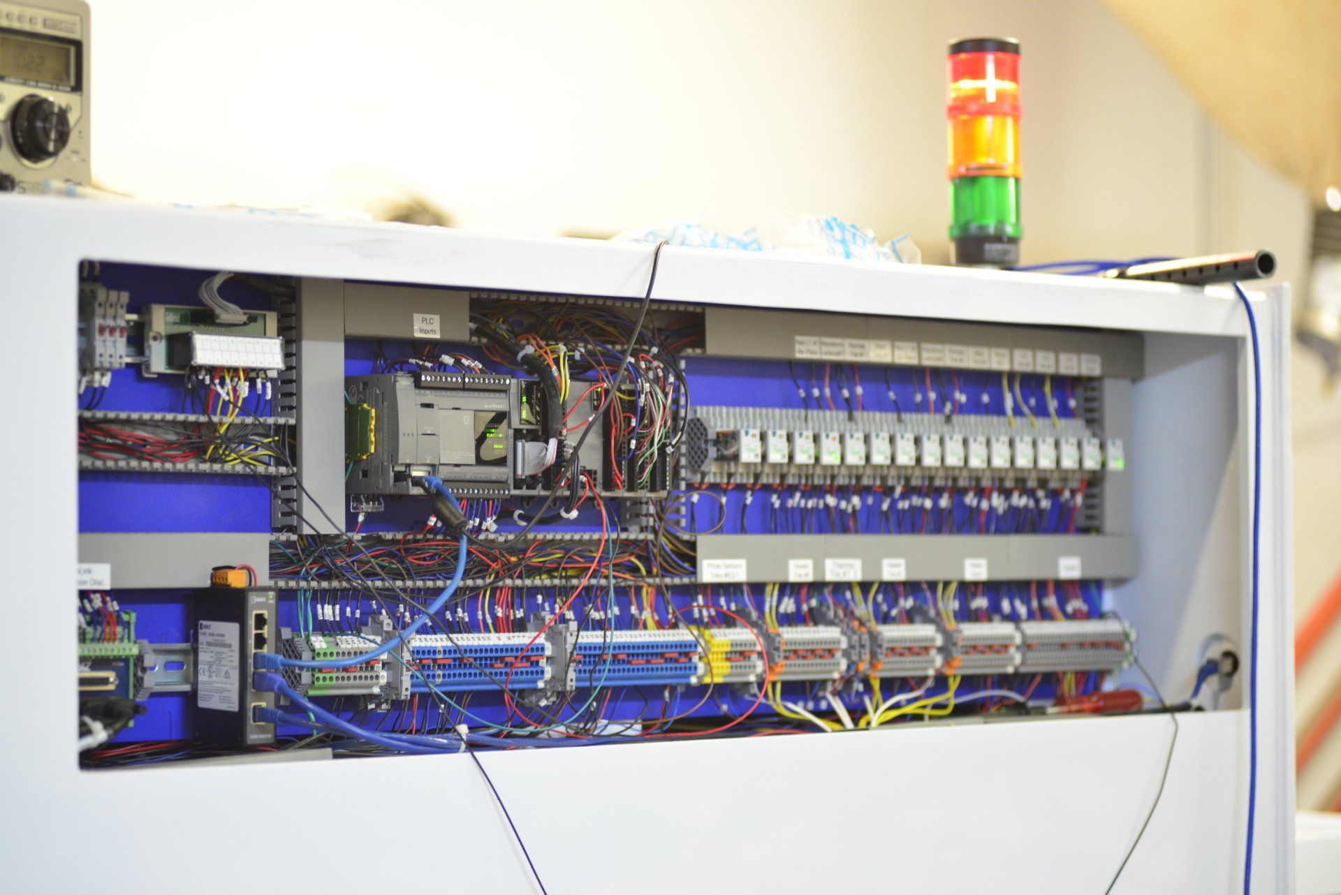 A white box with a lot of wires coming out of it