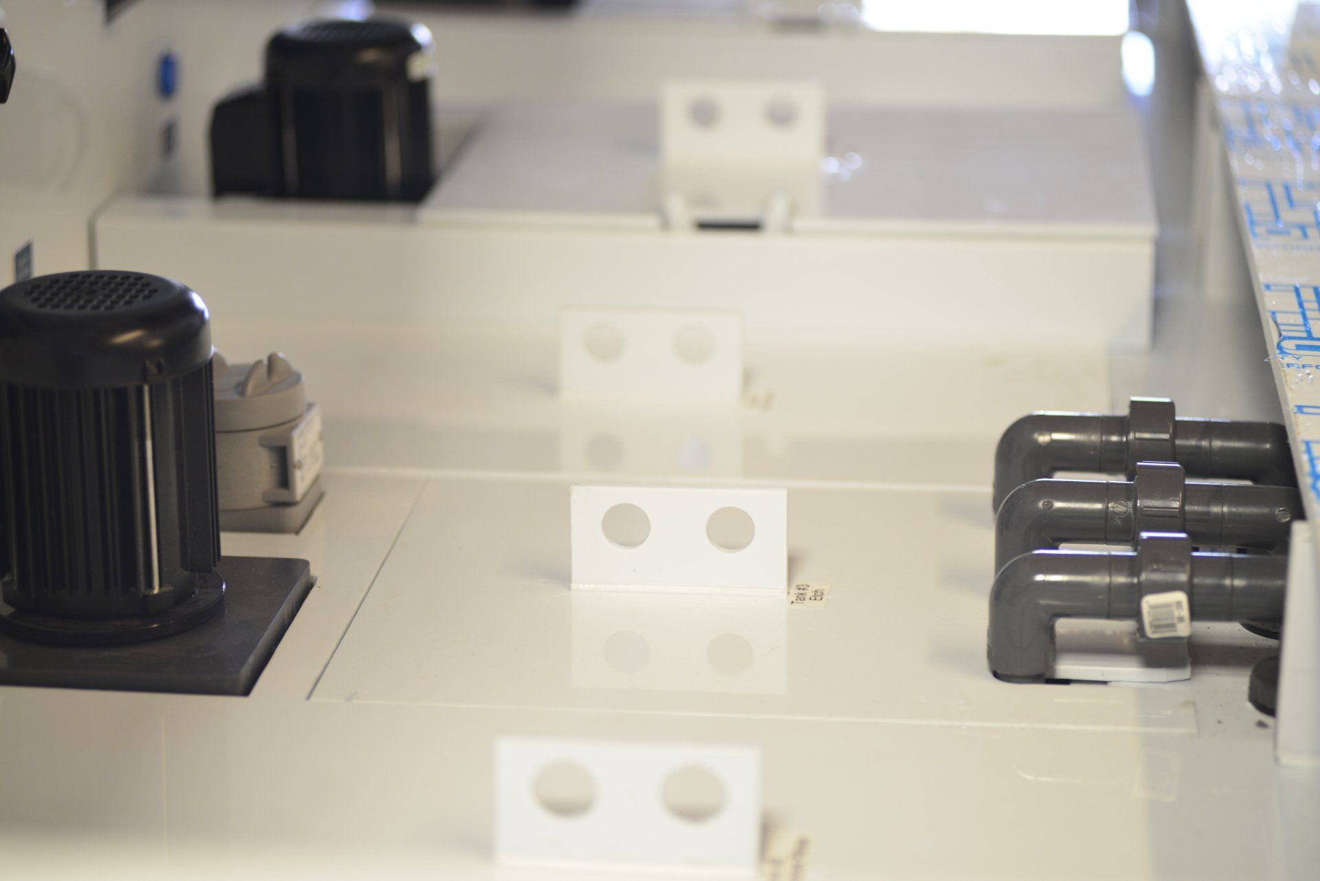 A close up of a white table with a black object on it.