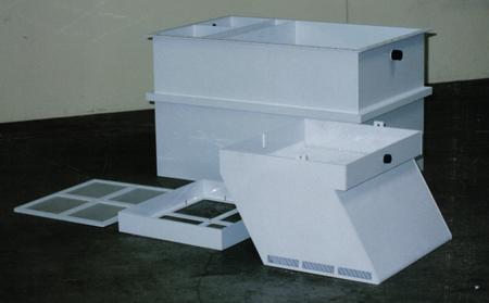 A white container with the lid open is sitting on the floor