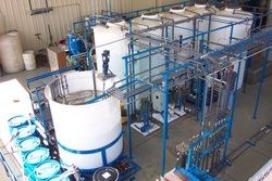 An aerial view of a factory with lots of tanks and pipes.