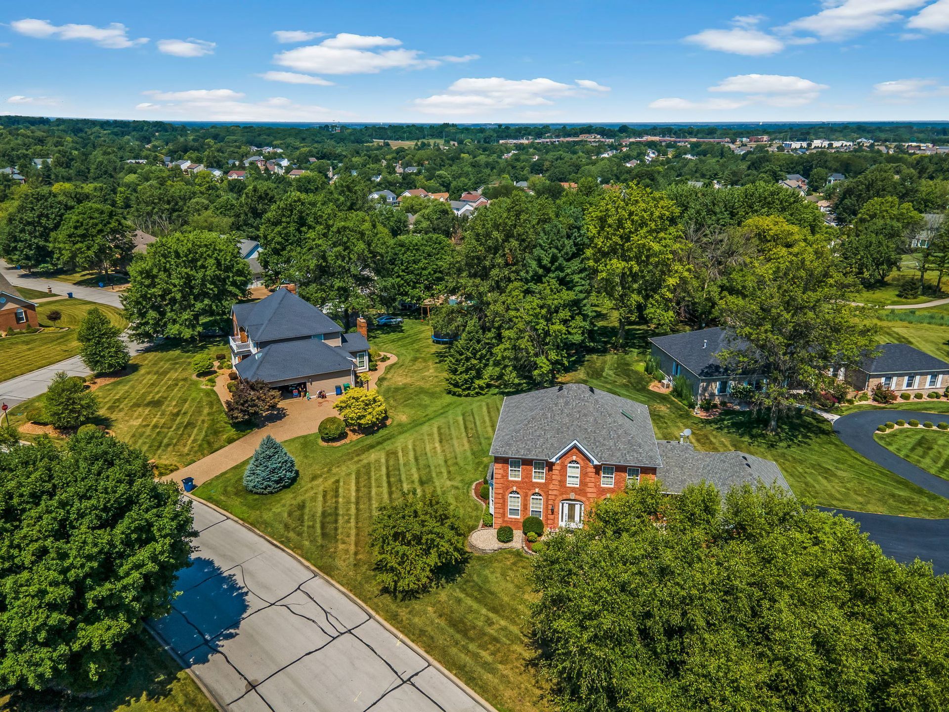 An aerial view of a residential area with houses and trees.