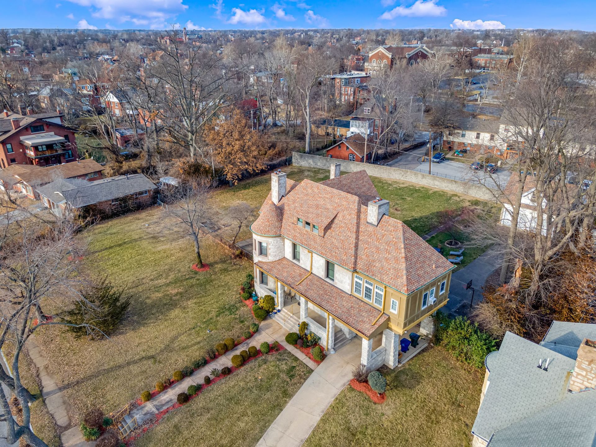 An aerial view of a large house in a residential area.