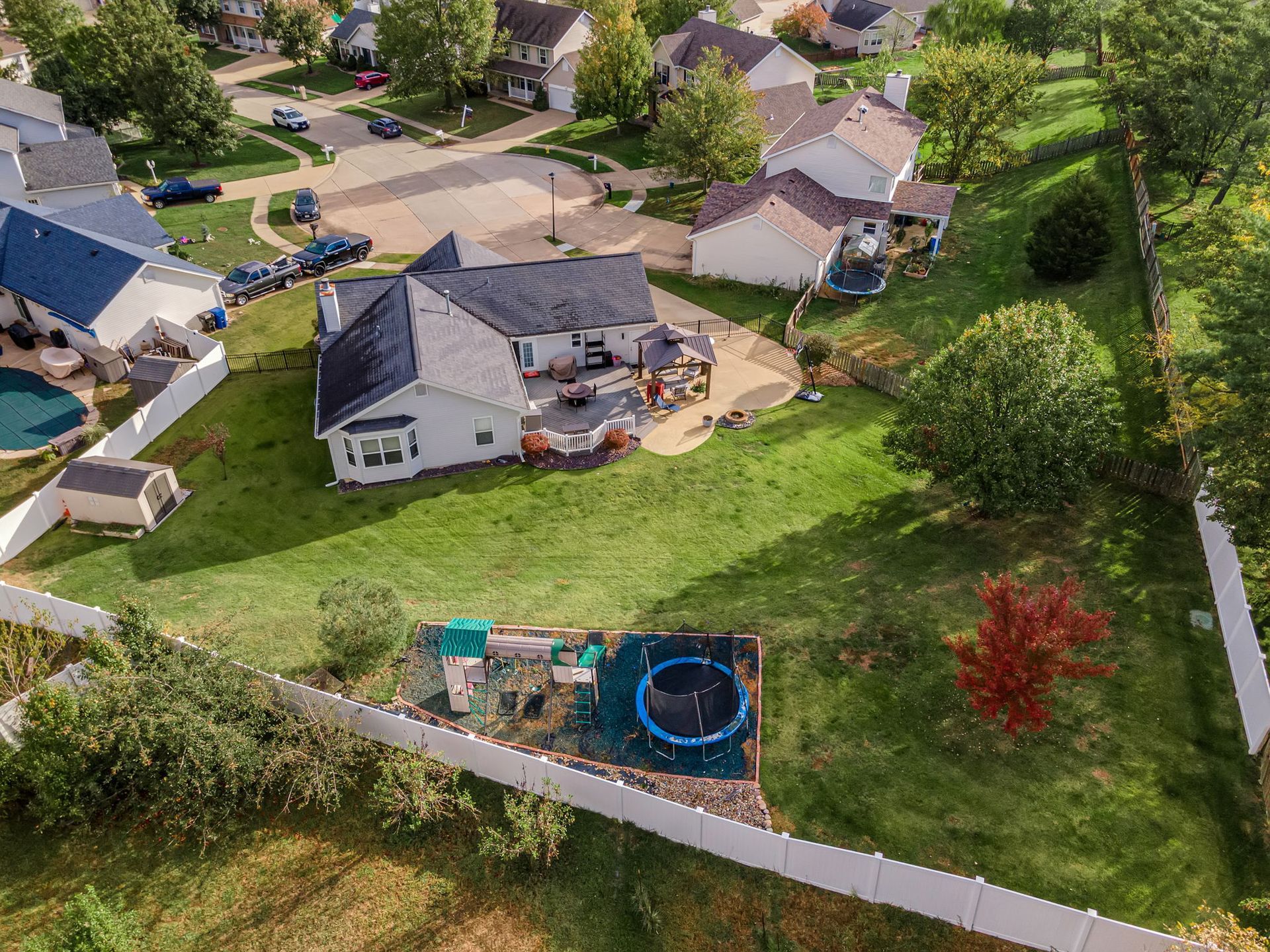 An aerial view of a residential area with houses and a playground.