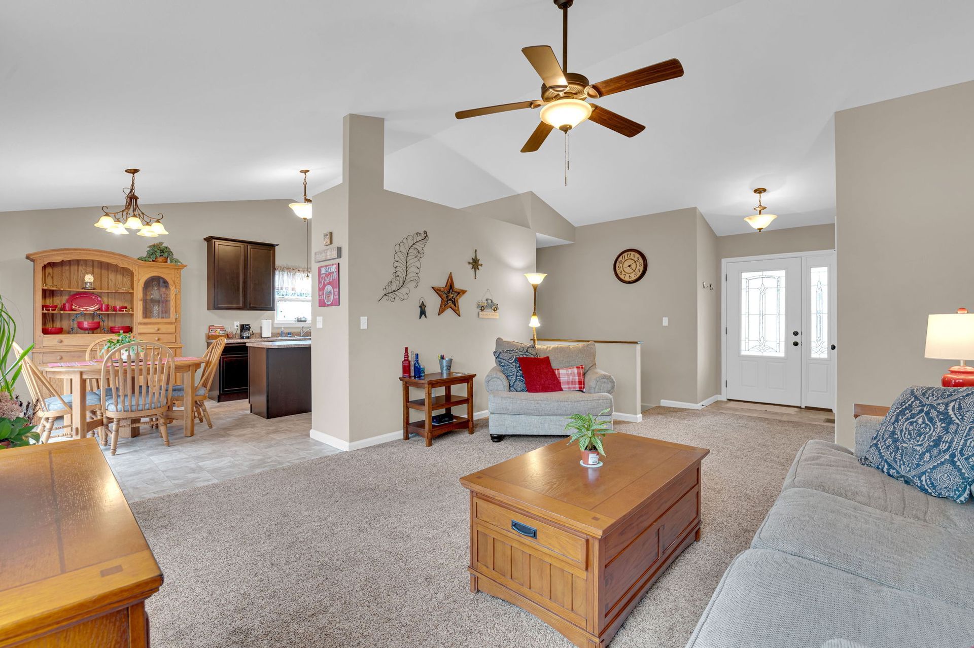 A living room filled with furniture and a ceiling fan.