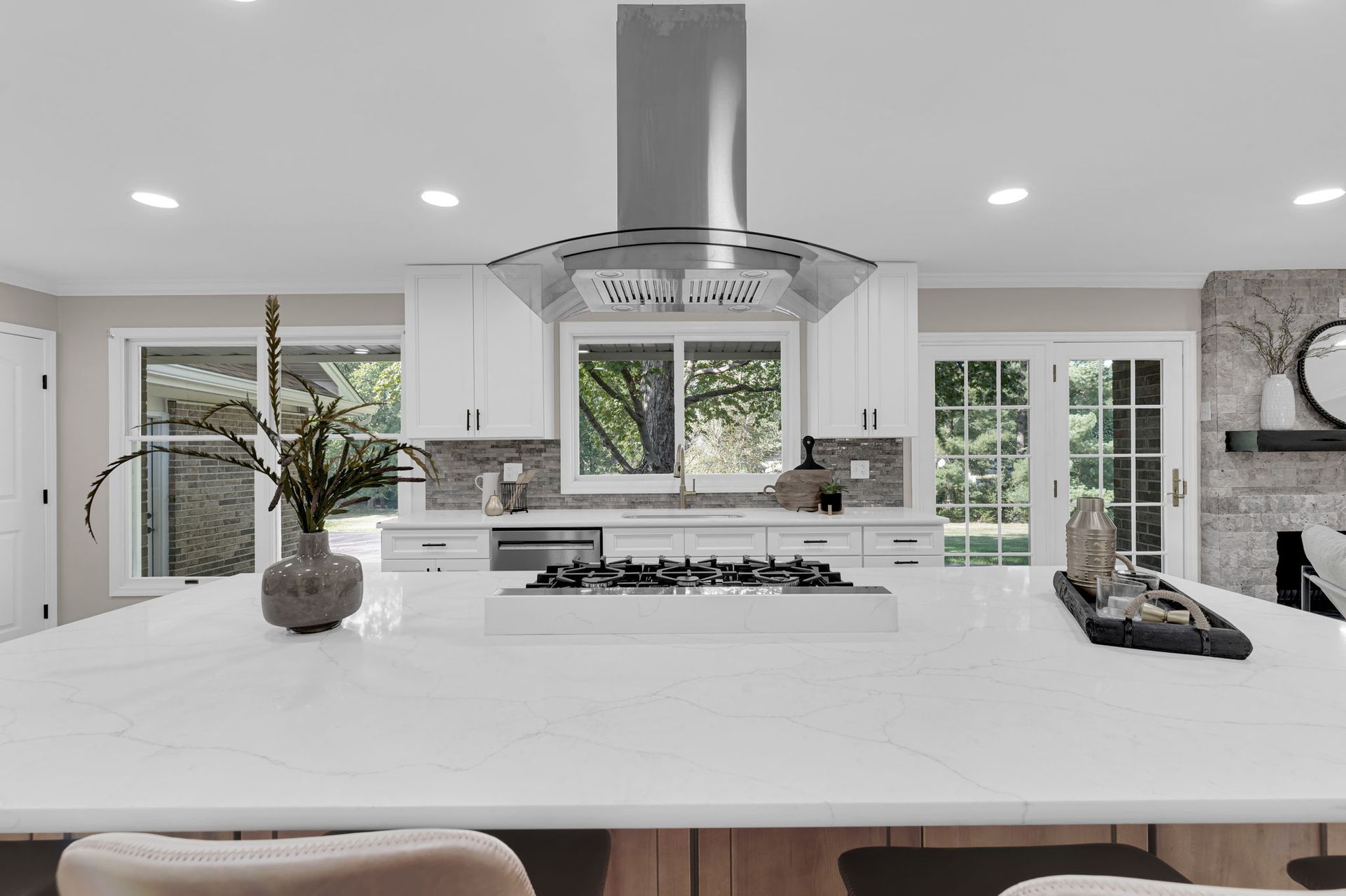A kitchen with a large island and a stove top oven.