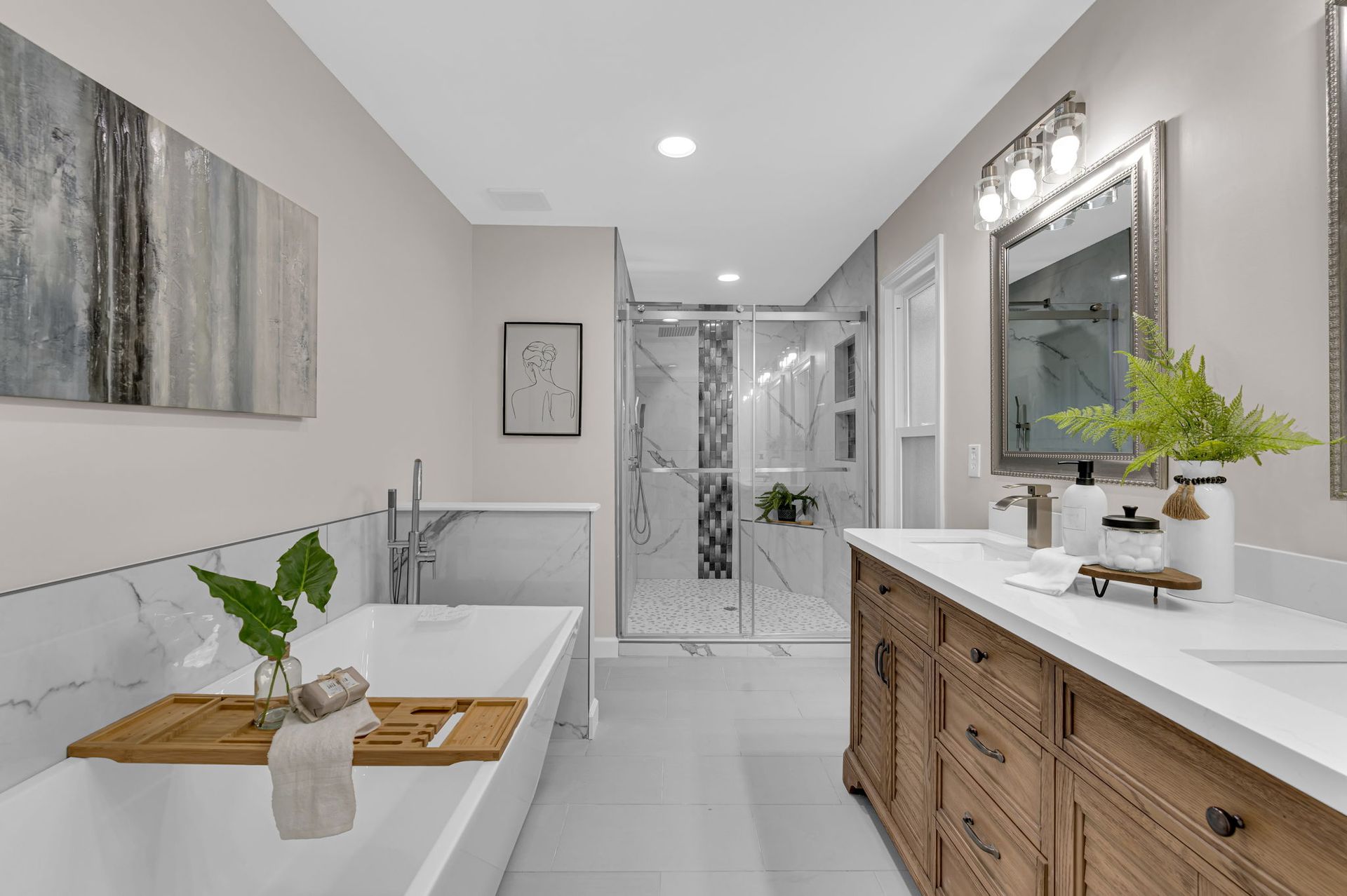 A bathroom with a bathtub , sink , mirror and walk in shower.