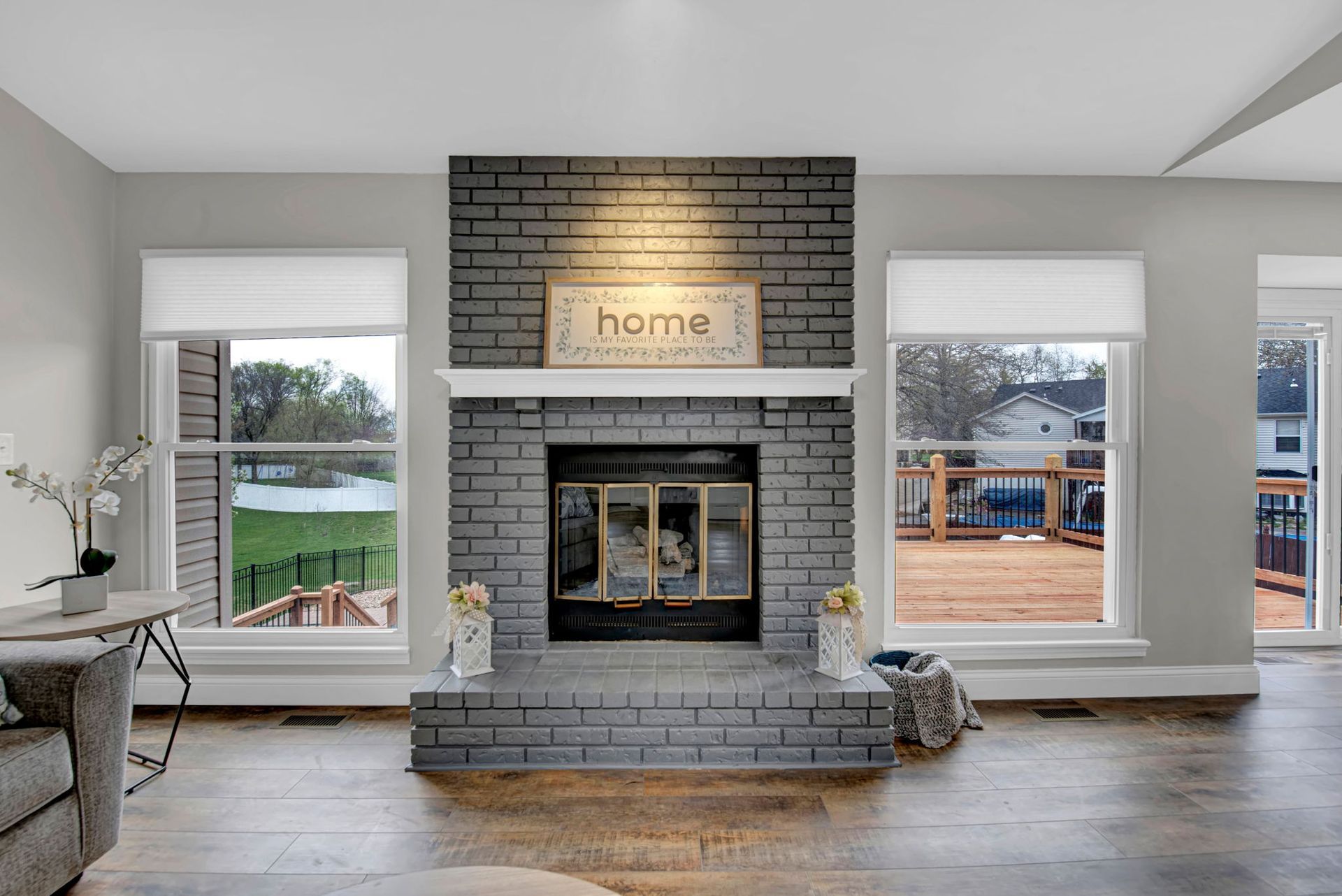 A living room with a fireplace and a sign that says home
