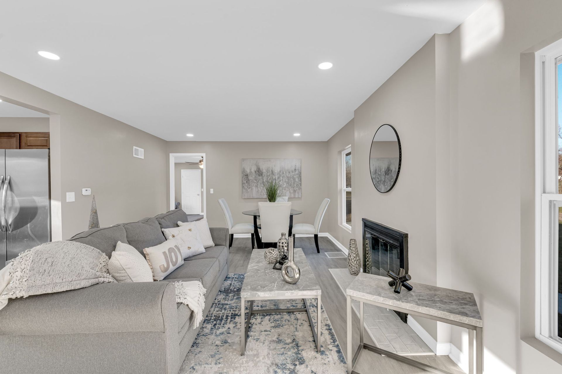 A living room with a couch , coffee table , and fireplace.