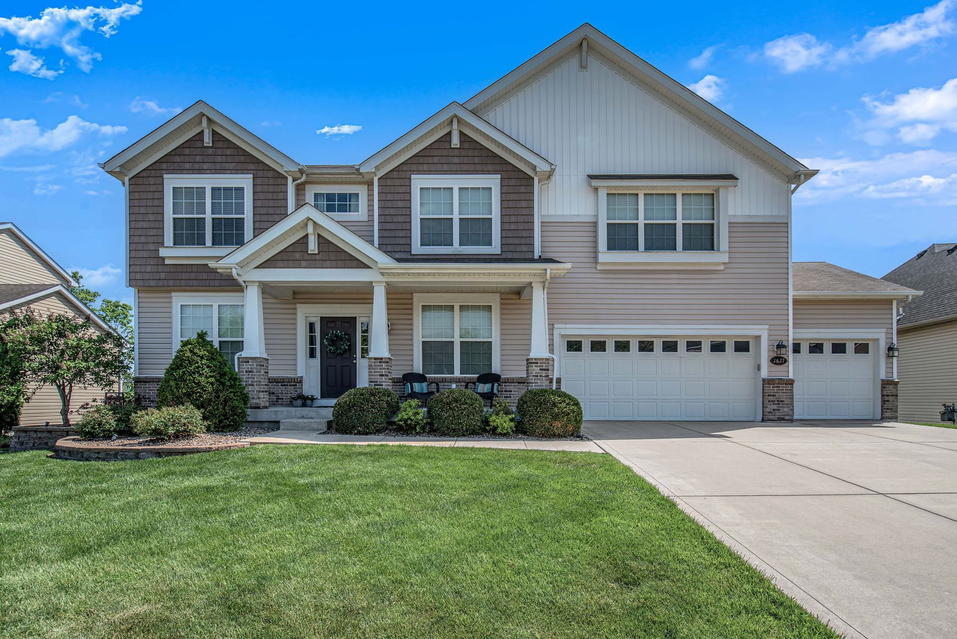 A large house with a lush green lawn in front of it.
