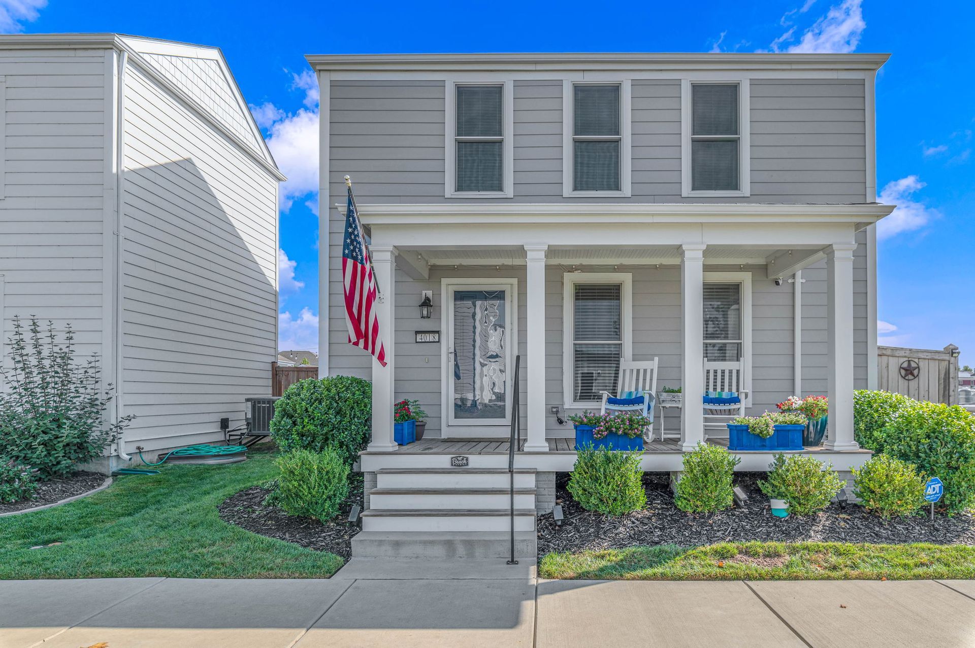 A house with a porch and an american flag on it