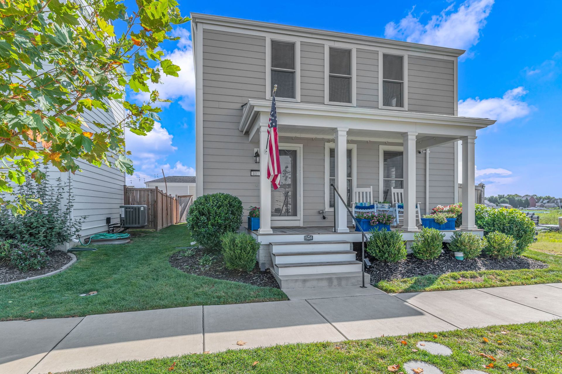 A house with a porch and an american flag on it