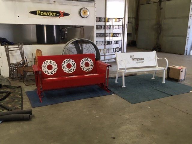 A red couch and a white bench in a room with a sign that says powder