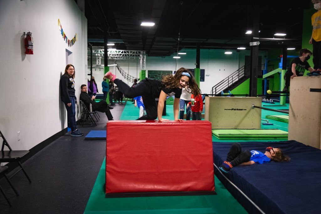 Girl climbing over obstacle
