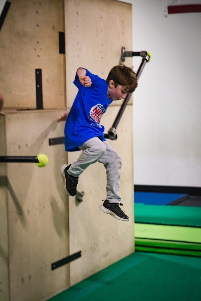 Young boy competing on the obstacle course