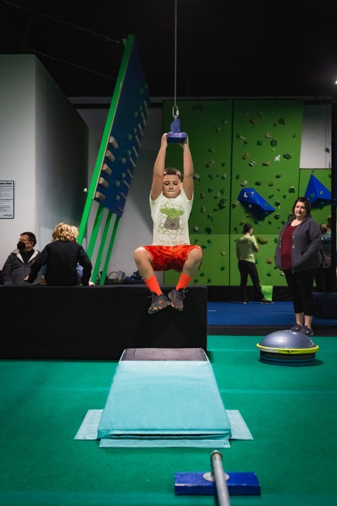 Kid hanging on rings